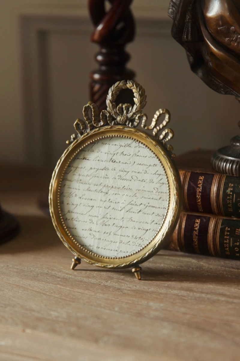 Late 19th Century French Louis XVI Style Oval Brass Photo Frame with Laurel Wreath Crest